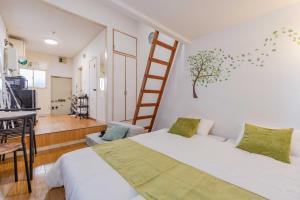 a bedroom with a bed and a ladder on the wall at Chihaya Relaxation Haven in Fukuoka +18 photos