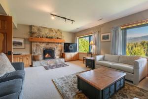 a living room with a couch and a fireplace at Heron Chalet by Outpost Whistler in Whistler
