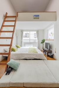 a bedroom with two beds and a ladder at Chihaya Relaxation Haven in Fukuoka