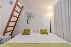 a bedroom with a bed with a tree mural on the wall at Chihaya Relaxation Haven in Fukuoka
