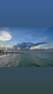 a group of people walking on the beach at Casa Tortuga in Chelem