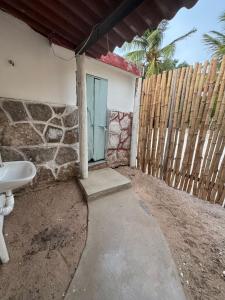 a bathroom with a sink and a fence at Casa Tortuga in Chelem