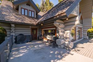 a house with a porch with a roof at Heron Chalet by Outpost Whistler in Whistler