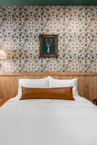 a bedroom with a white bed and a floral wallpaper at Sommer House Inn-Woodland Room in Jasper