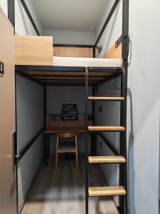 a room with a bunk bed and a desk at Happy Bear Youth Hostel in Beijing