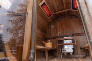 an inside view of a wooden sauna at Wooded Circle - Barrel sauna, hot tub, fire pit in Hico +43 photos