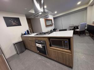 a kitchen with a stove and a counter top at Centro Zapopan in Guadalajara