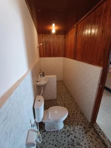 a bathroom with a toilet and a sink at SeaGarden Guesthouse in Bunaken