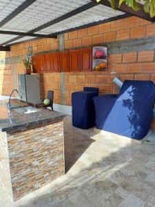 a kitchen with a sink and a brick wall at Casa Bella in Rivera