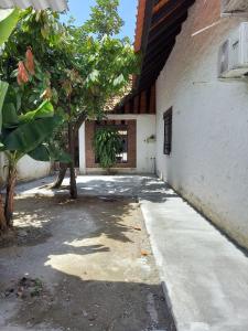 an empty sidewalk next to a building with a tree at Casa Bella in Rivera