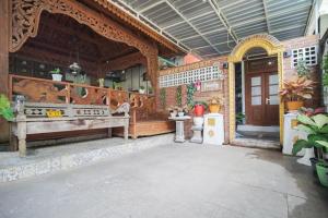 a porch of a house with a wooden fence at Villa Roemah Restoe Kolam Renang Private in Beran-kidul