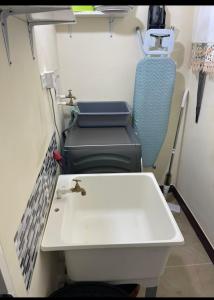 a bathroom with a sink and a toilet at Home to Comfort in Old Harbour