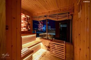 a sauna with a bench in a wooden room at The SONG - Căn Hộ Biển Và Hồ Bơi Vô Cực - Beach Apartment and Infinity Pool in Vung Tau