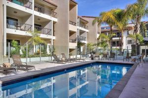 a swimming pool in front of a building at Beachfront Hideaway in Santa Barbara