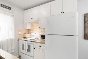 a kitchen with white cabinets and a white refrigerator at Downtown location Near the Beach Dog Friendly in Edmonds