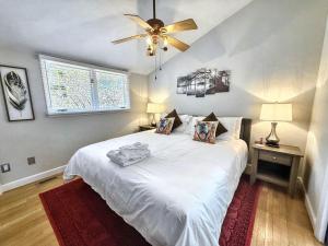 a bedroom with a white bed with a ceiling fan at 826 Wilson Road in Highlands