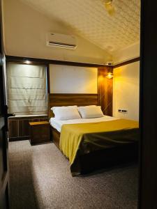 a bedroom with a large bed in a room at The Mallika Holidays in Mananthavady