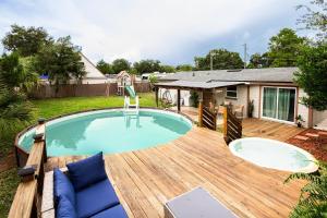 a swimming pool on a wooden deck next to a house at Private Pool, Hot Tub & Game Room Retreat in Jacksonville