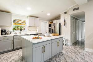 a kitchen with white cabinets and white counter tops at Light & Cozy Oasis in Jacksonville