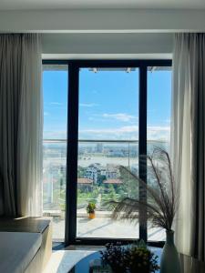 a large window with a view of a city at Beer Homestay Nera Garden Hue in Hue