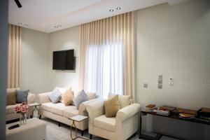 a living room with a couch and a tv at aroya in Jeddah