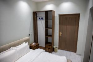 a bedroom with a bed and a closet and a door at aroya in Jeddah +14 photos