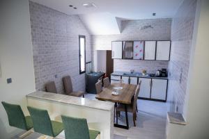 a kitchen and dining room with a table and chairs at aroya in Jeddah