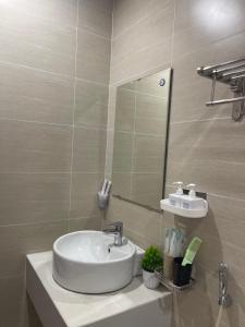 a bathroom with a sink and a mirror at Beer Homestay Nera Garden Hue in Hue +3 photos