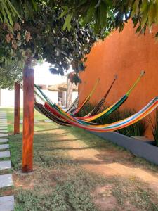 a hammock tied to a fence in a yard at Pousada Jalapão Sunset in Mateiros