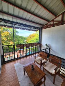 a room with a table and chairs and a large window at 88 Tourist Inn by Lagum Adventure in Coron