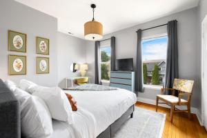 a bedroom with a bed and a tv and a window at King Bed, Near DT and Best Restaurants, Pets OK! in Tacoma