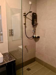 a shower with a glass door in a bathroom at KM Barakah Suite in Kuala Terengganu +59 photos