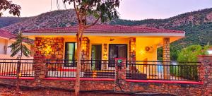 una casa amarilla con una valla delante en Girivan, en Alwar