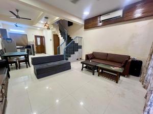a living room with a couch and a table at Candy Stay's 2BHK with Pvt Pool in Lonavala