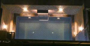 a large swimming pool with lights on top of it at Candy Stay's 2BHK with Pvt Pool in Lonavala