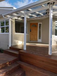 a pergola on a house with a wooden deck at Sweet on Sutton in Richmond