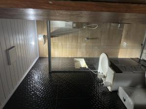 a bathroom with a toilet and a shower at Quarto Suite in Mucugê
