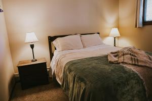 a bedroom with a large bed with two lamps at Breck Ski Chalet, Pet Friendly, Private Hot Tub and Scenic Views in Breckenridge