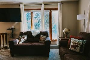a living room with a couch and a large window at Breck Ski Chalet, Pet Friendly, Private Hot Tub and Scenic Views in Breckenridge