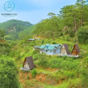 a group of houses on a hill with trees at The Sound Of Silence Homestay Đà Lạt in Da Lat