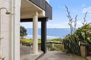 a house with a view of the ocean at Wow On Wanaka Bay - beachfront living at its best in New Plymouth