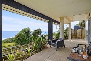 an ocean view from the porch of a house at Wow On Wanaka Bay - beachfront living at its best in New Plymouth +27 photos