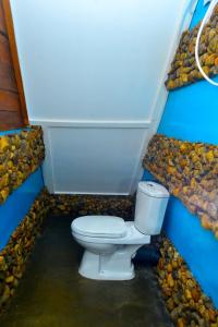 a bathroom with a toilet in a pile of rocks at moye moye Ella in Ella