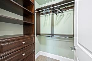 a walk in closet with a wooden dresser at 1 Bedroom Luxury Retreat in Prime Vancouver in Vancouver +12 photos