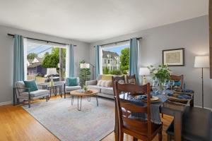 a living room with a table and a couch at Walk to Dining & Waterfront, Spacious with Best Beds in Tacoma