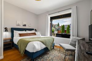 a bedroom with a bed and a window at Walk to Dining & Waterfront, Spacious with Best Beds in Tacoma