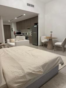 a bedroom with a large bed and a kitchen at Yas island Golf collections in Abu Dhabi +12 photos