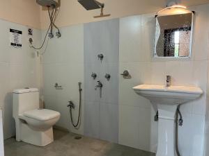a bathroom with a toilet and a sink at Daarapari in Kaluk +30 photos
