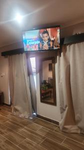 a flat screen tv sitting on top of a wall at Tucked away with a pool view in White River