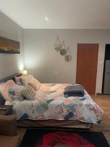 a bedroom with a bed with a quilt on it at Tucked away with a pool view in White River